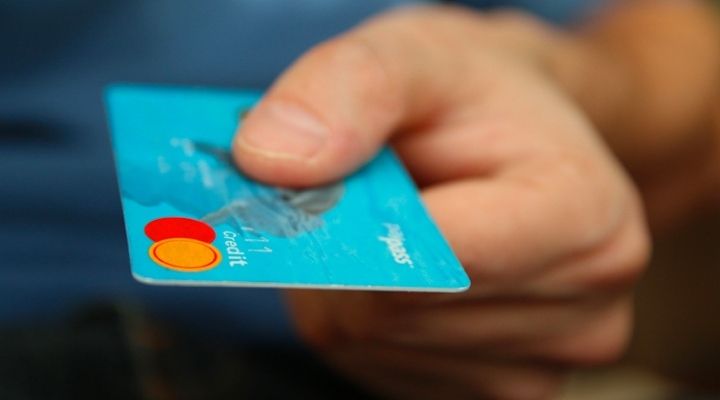 Person holding a credit card Person holding a credit card